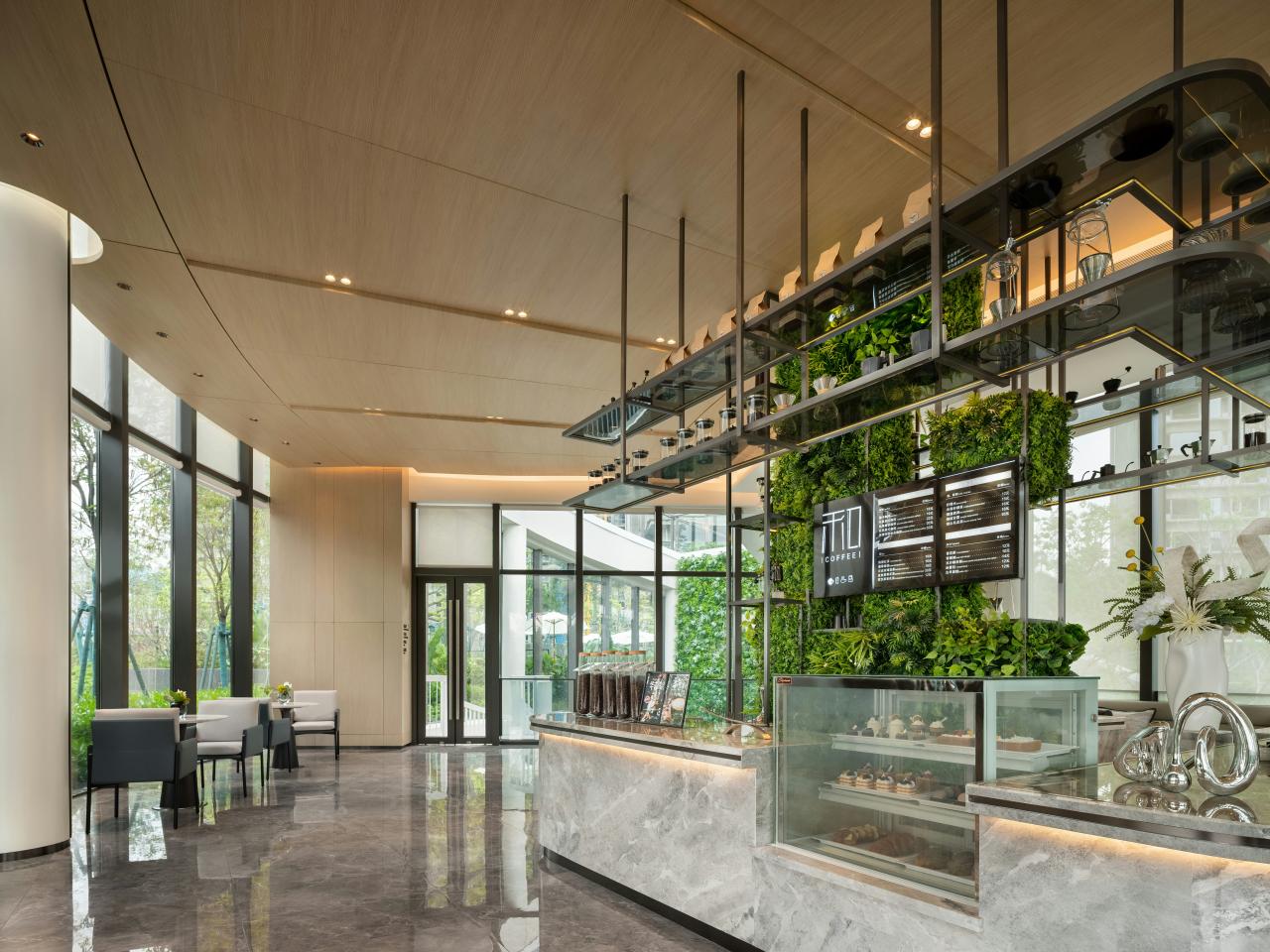 Modern cafe interior with plants and display counter