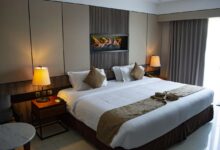 white bed linen with throw pillows