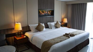 white bed linen with throw pillows