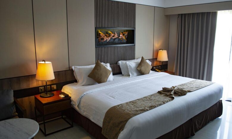 white bed linen with throw pillows