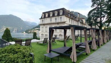 A large building with a lawn and picnic tables in front of it